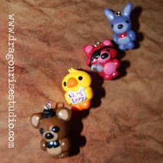 three little toy animals sitting next to each other on a brown surface with words written below them