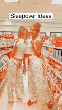 two women taking a selfie in a grocery store with orange juice on the shelves