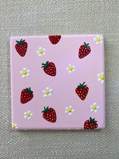 a pink square with strawberries and daisies on it, painted in acrylic