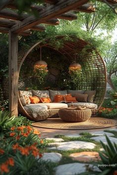 an outdoor seating area with lots of plants and flowers