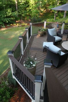 a deck with chairs and an umbrella on it