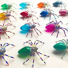 colorful spider figurines are arranged on a white surface