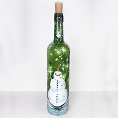 a bottle with a snowman painted on it