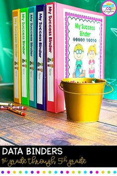 a bucket full of books sitting on top of a wooden table