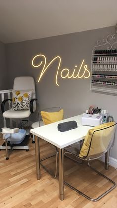 a nail salon with chairs and lights on the wall