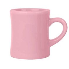 a pink coffee mug sitting on top of a white table