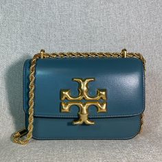 Eleanor Small Convertible Shoulder Bag/Cross Body Bag By Tory Burch. This Bag Is Made Of Brisk Blue Textured Genuine Smooth Leather. This Bag Is Convertible. Can Be Carried As A Shoulder Bag Or Cross Body Bag. Dimensions: 7.5" Wide Across Bottom X 5" Tall Center X 2.5" Deep. Strap Drop Doubled 11.5", Single 22". Interior: 3 Compartments. 1 Zipper Compartment Flap Closure Secured With Magnetic Button. Leather Interior. Gold Tone Metalware. Comes With Dust Bag !!! Blue Shoulder Bag With Gold-tone Hardware For Errands, Tory Burch Navy Blue Bag, High-end Blue Crossbody Shoulder Bag, Blue Crossbody Box Bag With Gold-tone Hardware, Blue Crossbody Shoulder Bag With Gold-tone Hardware, Blue Texture, Tory Burch Bag, Small Shoulder Bag, Cross Body Bag