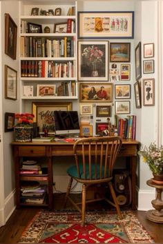 a home office with lots of books and pictures on the wall