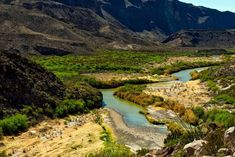 a river running through a lush green valley