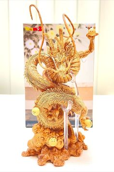 a golden dragon figurine sitting on top of a table