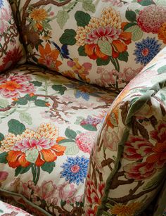 an upholstered chair with colorful flowers on it