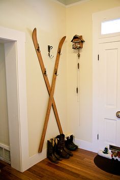 a pair of skis hanging on the wall next to a pair of snow shoes