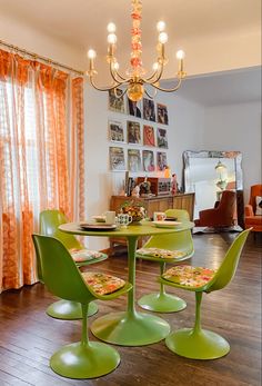 a green table and four chairs in a room