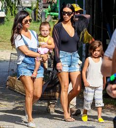 the two women are walking with their children