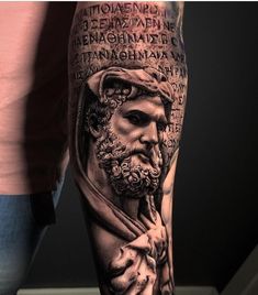 a man's leg with an image of the greek god and his name on it