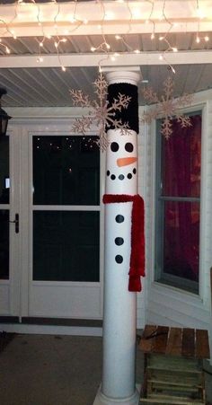 a snowman made out of toilet paper on top of a pole