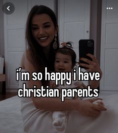 a woman taking a selfie with her baby on her lap and the caption says i'm so happy i have christian parents