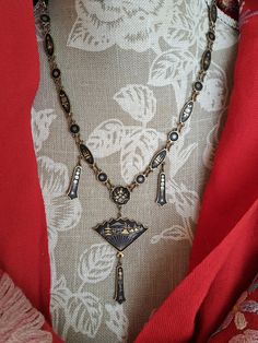 This is a stunning very rare antique shakudo necklace.The necklace is Japanese and was made in the 1920s era.The necklace is made of brass and black enamels.The necklace consists of a series of medallions,oval and round,all linked together.Hanging from the necklace is a beautiful fan.All the pieces are handpainted in 24ct gold.The designs feature traditional Japanese scenes of landscapes featuring trees,water,mountains,pakodas.All executed in beautiful fine design and workmanship.The handpainting is superb.Its a rare piece and looks lovley on.The necklace is in very good condition, but does have some wear and tear.Please study the pictures.The necklace is 46cm long.The pretty alligator clip works well. .The necklace comes with a velvet drawstring bag. We opened our art and Vintage jewelry Japanese Necklace, Antique Gold Locket, Heart Piercing, Necklace Art Deco, Victorian Locket, Japanese Jewelry, Antique Turquoise, Antique Locket, Unique Brooch