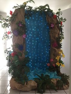 a blue screen with flowers on it in the middle of a tiled floored room