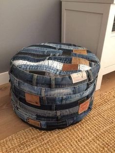 a round ottoman made out of old jeans