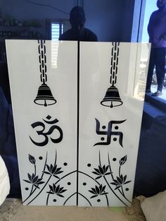 the door is decorated with black and white designs on it's sides, which have bells hanging from them