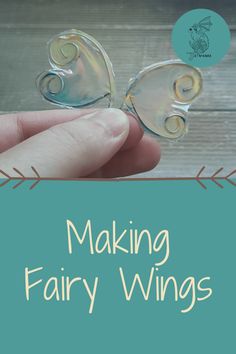 a hand holding a glass butterfly with the words making fairy wings on it