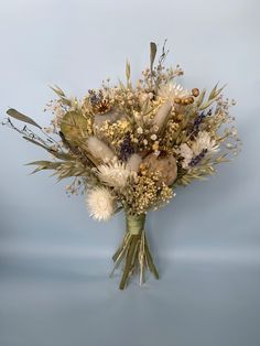 a bouquet of dried flowers on a blue background