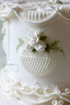 a wedding cake with white frosting and flowers on it