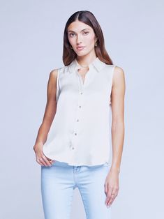 An essential sleeveless blouse in ivory silk. Relaxed-fit style has classic shirting details like smart collar, back yoke with loop, and shirttail hem. Luxe mother-of-pearl button closure. 100% Silk. | L'AGENCE Emmy Blouse Top In Ivory Sleeveless Silk Blouse, Ivory Silk, Mother Of Pearl Buttons, Fit Style, Blouse Top, Sleeveless Blouse, Black Blouse, Silk Blouse, Summer Collection