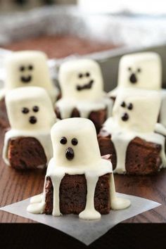 some brownies with white frosting and ghost faces on them