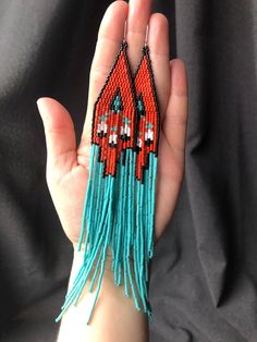 Elegant earrings in ethnic style, an original combination of matte red with glossy turquoise color. Very long and spectacular. They fit everyday and festive creations. They were made of Miyuki beads. Colors: matt red, turquoise, matt white, black Length- 19 cm Width - 2,5 cm Stainless steel earrings in silver Cow Print Fringe Earrings, Red Fringe Earrings, Seed Bead Jewelry Patterns, Beads Colors, Native American Beaded Earrings, Beaded Earring, Brick Stitch Earrings, Beaded Earrings Patterns, Matte Red