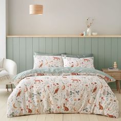 a bed in a bedroom with an animal themed comforter