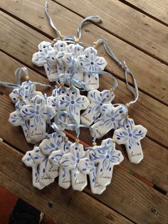 several ceramic ornaments are arranged on a wooden table with string attached to the top and bottom