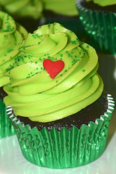 cupcakes with green frosting and red heart on top