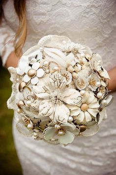 a bridal holding a bouquet of seashells and pearls