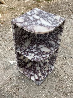 three tiered marble shelf sitting on the ground