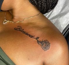 a woman with a rose tattoo on her back and the word roses written in cursive writing