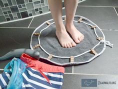 a person standing on top of a gray rug