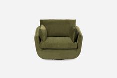 the green chair is sitting in front of a white wall and it's legs are up