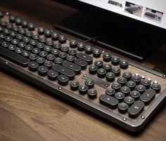 a computer keyboard sitting on top of a wooden desk