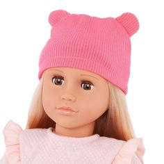 a doll with blonde hair wearing a pink sweater and beanie hat on her head