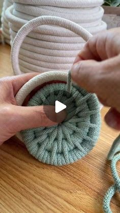 someone is making a crochet basket with yarn