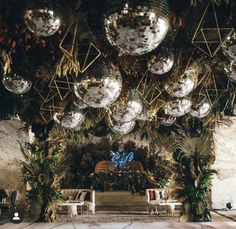 disco balls hanging from the ceiling in an indoor venue