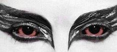 the eyes of a woman with black and white make - up on her face are red