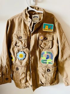 Inspired by nature and adventure. Summer camping trips and scouts! This is a thrifted Gymboree jacket in a size 7/8. I hand painted the back, added patches and a pin for extra personality!  All patches are reinforced with hand stitching. This item can be machine washed on gentle or hand washed.  All jackets are one of a kind. I can recreate this jacket in the size you need but the style and patching will be different. Casual Outdoor Outerwear With Logo Patch, Casual Outerwear With Logo Patch, Casual Outerwear With Patches For Outdoor, Long Sleeve Outerwear With Patches For Outdoor, Casual Outdoor Outerwear With Patches, Vintage Cotton Utility Jacket For Outdoor Activities, Outdoor Cotton Outerwear With Logo Patch, Vintage Cotton Utility Jacket For Outdoor, Casual Adventure Outerwear With Multiple Pockets