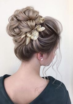 a woman with blonde hair and flowers in her hair is wearing a black top, while she