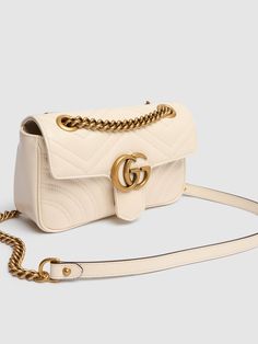 Find GUCCI Mini Gg Marmont Leather Shoulder Bag on Editorialist. The Gucci Gg Marmont Leather Shoulder Bag features a front flap with snap button closure, a metal logo detail, a back decorative stitched heart detail, and one internal pocket. The bag measures 13cm in height, 22cm in width, and 6cm in depth. It has an adjustable metal chain shoulder strap with a leather insert and a shoulder strap drop of 30cm. This luxurious shoulder bag can be worn crossbody or on the shoulder. Gucci Mini, Versace Brand, Girly Bags, Ski Accessories, Gucci Gg Marmont, Gg Marmont, Metal Logo, Heeled Loafers, Metallic Logo