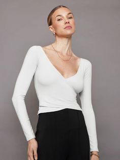 The Long Sleeve Wrap Top is a chic, slightly cropped style that encases you in our buttery soft Melt fabric that you know and love. It features an open ballet back and a front mock-wrap detail. With it's clean lines and luxe feel, this piece will elevate any look. Chic Stretch Long Sleeve Wrap Top, Fitted Long Sleeve Chic Wrap Top, Versatile Stretch Long Sleeve Wrap Top, Chic White Long Sleeve Wrap Top, Versatile White Wrap Top, Long Sleeve Wrap Top, Carbon 38, Joan Smalls, Full Look