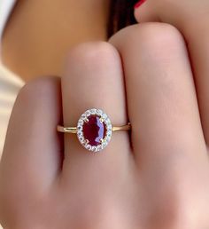 Ruby Gold Ring - Natural Ruby Gemstone Gold Ring - Dainty Gold Jewelry - Ruby Women Promise ring - Gift For Wife - Solitaire Ruby Ring *100% natural gemstone *14k solid gold *solid gold (NOT plated) *gemstone: ruby *gemstone: zircon *stone shape ruby: oval *stone shape zircon: round *stone ruby : 5x7 mm. *stone ruby ct. : 1.00-1.20 ct. *stones ruby : 1 pc. *stone zircon : 20 pcs. Timeless Ruby Ring With Halo Setting As A Gift, Gia Certified Oval Ruby Ring For Wedding, Oval Ruby Ring With Diamond Halo, Fine Jewelry Ruby Ring With Cluster Halo Setting, Fine Jewelry Ruby Ring With Halo Cluster Setting, Fine Jewelry Ruby Ring With Halo Design, Oval Ruby Ring With Halo In Fine Jewelry Style, Gia Certified Oval Ruby Ring Gift, Fine Jewelry Ruby Ring With Halo