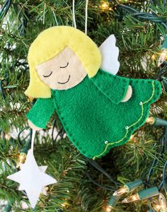 a felt angel ornament hanging from a christmas tree